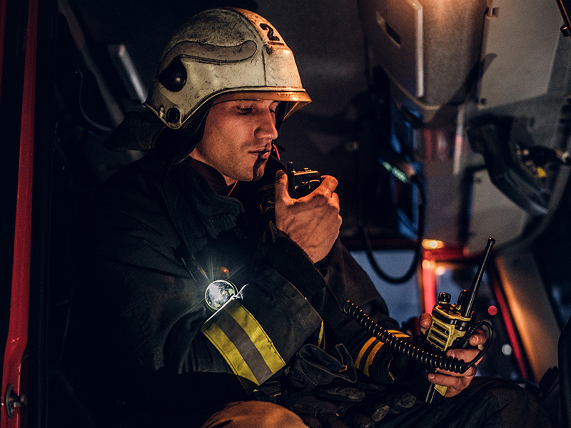 fireman-wearing-protective-uniform-standing-next-t-QXNWNGJa.jpg